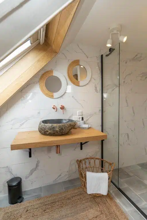 salle de douche avec lavabo en pierre dans une des chambres de l'hôtel Op Oost de Texel